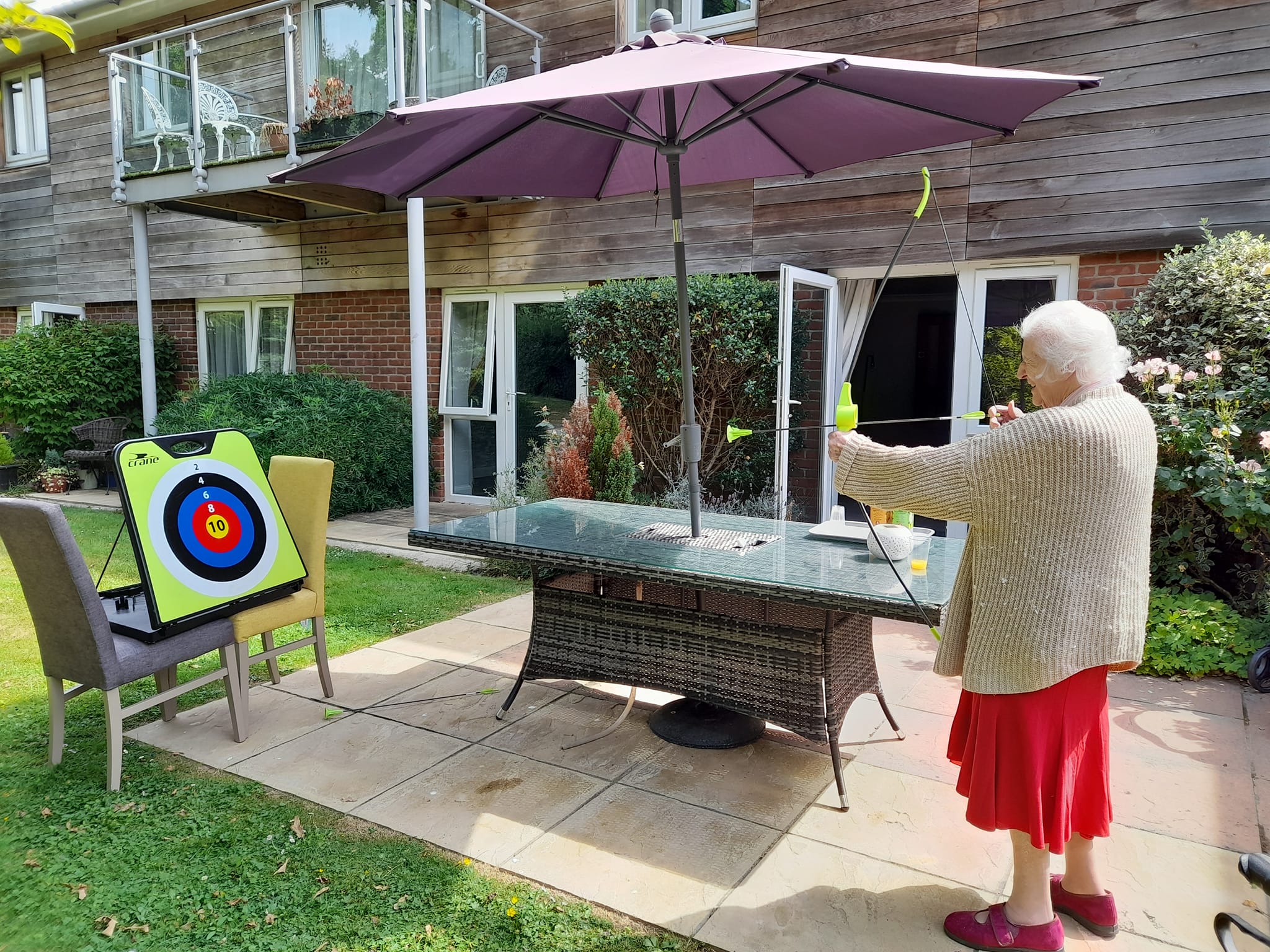 Knightwood resident playing archery outside