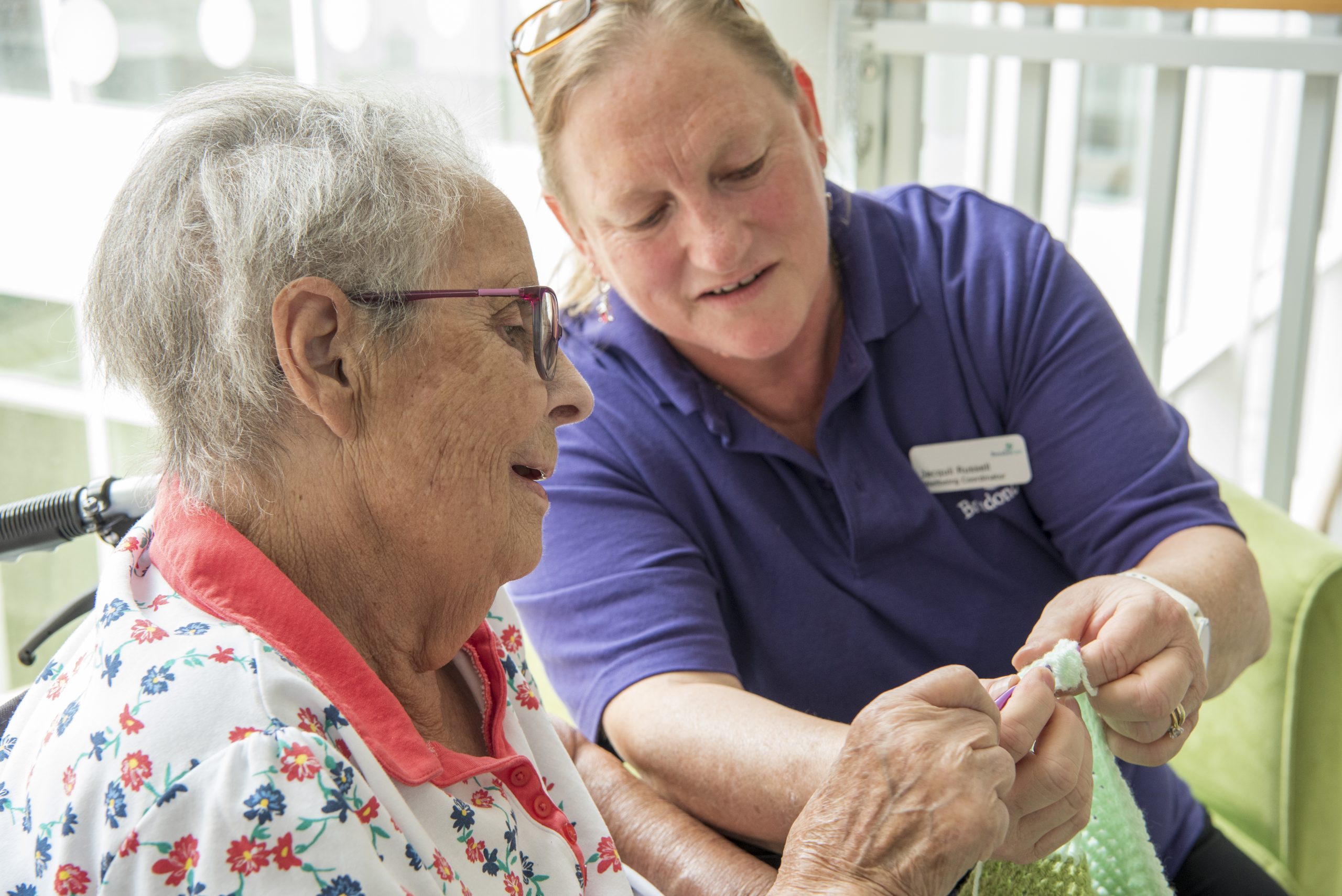 Wellbeing coordinator and resident knitting - Alton