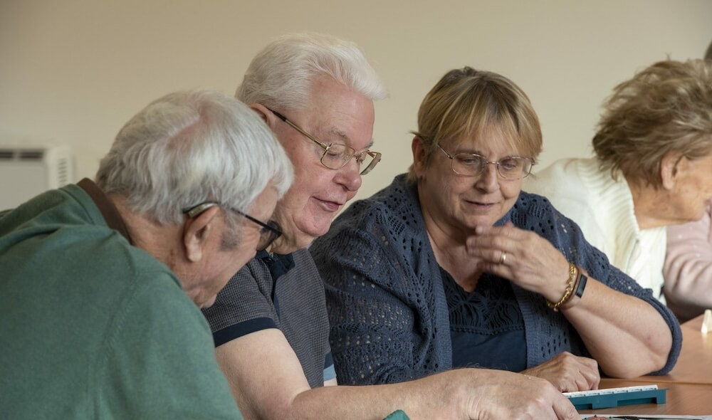 older persons playing scrabble at Brendoncare community club
