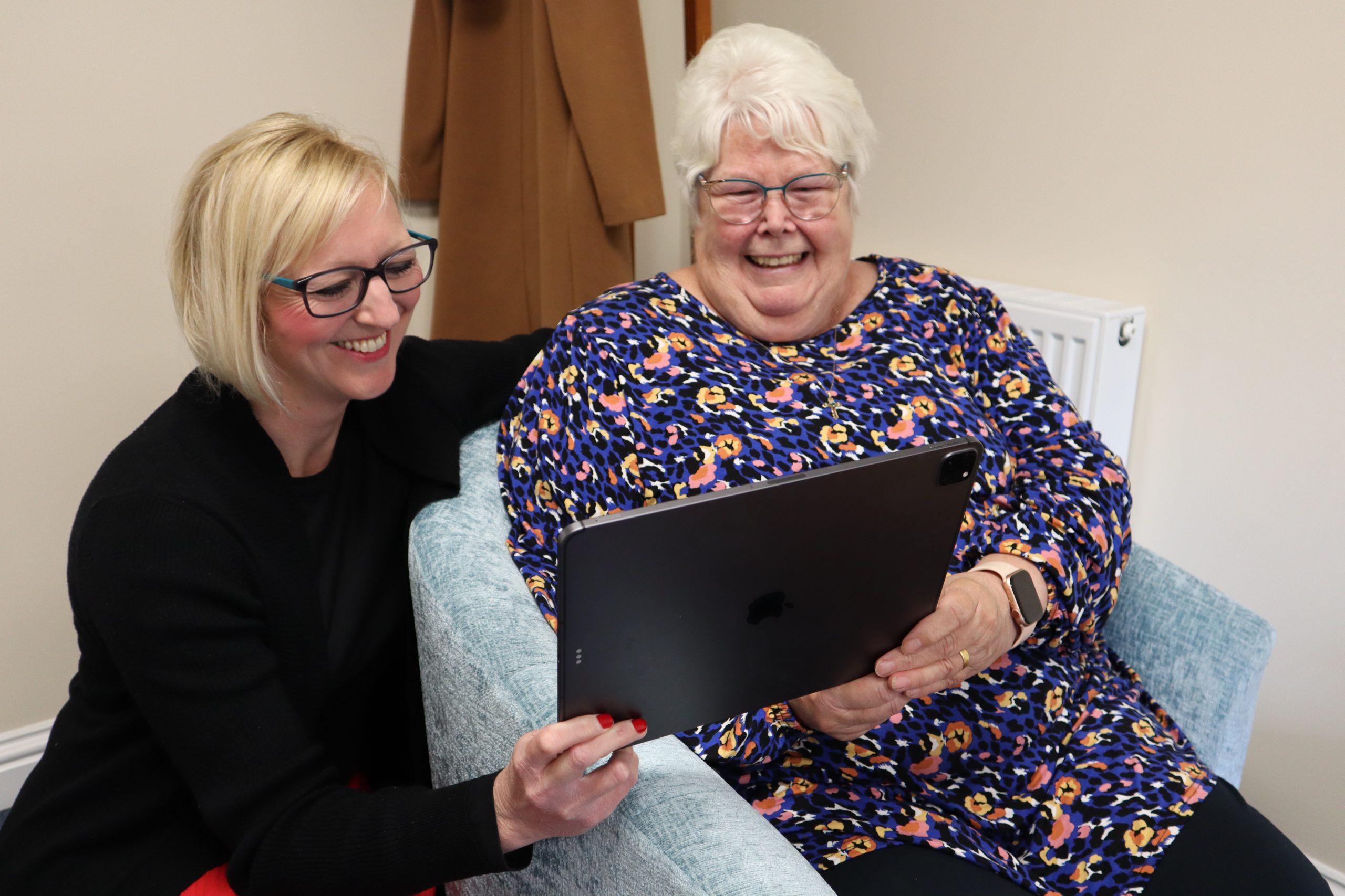 Older person being supported to learn technology