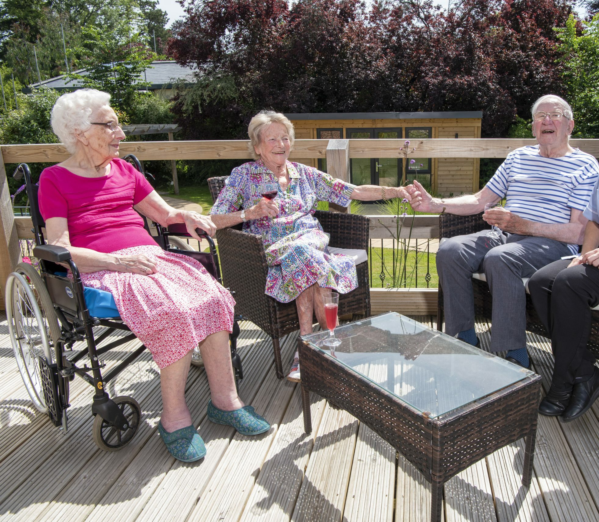 Meadway residents laughing in garden with carer