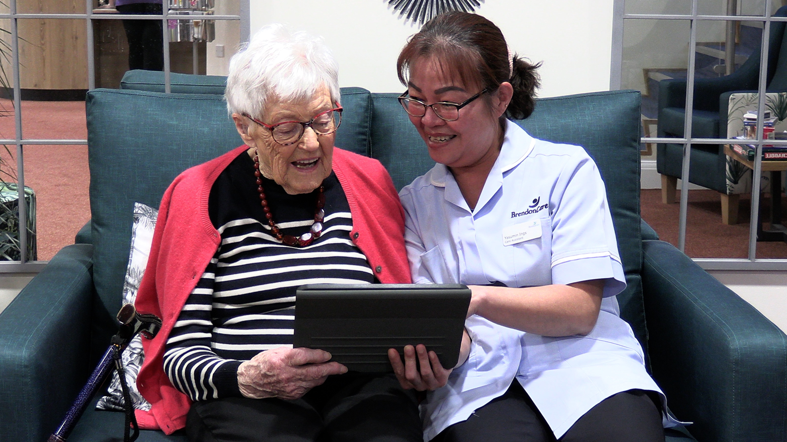 Digital: Older person and carer using ipad in care home