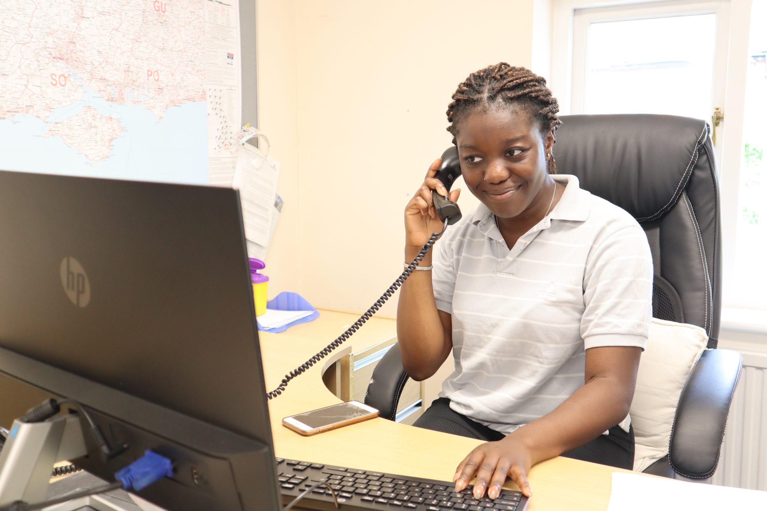 Young volunteer on telephone remotely